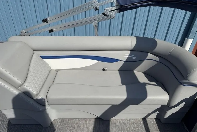 Slide: The Image of 2023 Bennington 22 boat interior with gray and blue cushioned seating. - 19