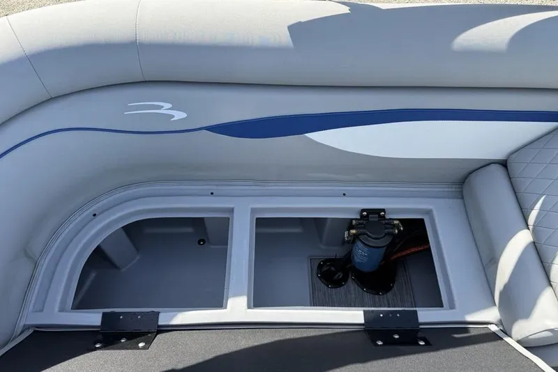 Slide: The Image of 2023 Bennington 22 boat interior storage compartment with pump system, featuring sleek design. - 20