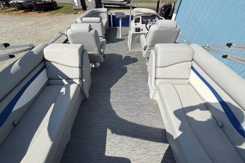 Slide: The Image of 2023 Bennington 22 pontoon boat interior with gray seating and blue accents. - 24