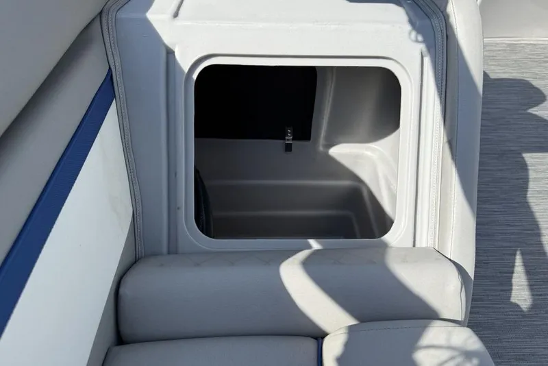 Slide: The Image of 2023 Bennington 22 boat storage compartment with cushioned seating and sleek design. - 25
