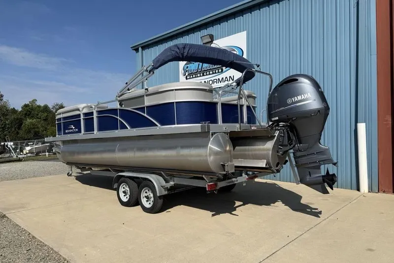 Slide: The Image of 2023 Bennington 22 pontoon boat with Yamaha motor on trailer, parked outside. - 4