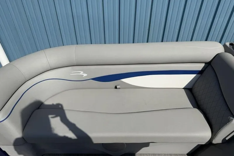Slide: The Image of 2023 Bennington 22 boat seat with gray upholstery and blue accents. - 6
