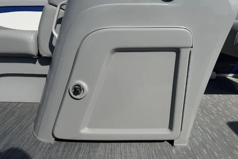 Slide: The Image of 2023 Bennington 22 boat interior with gray storage compartment and seating. - 7
