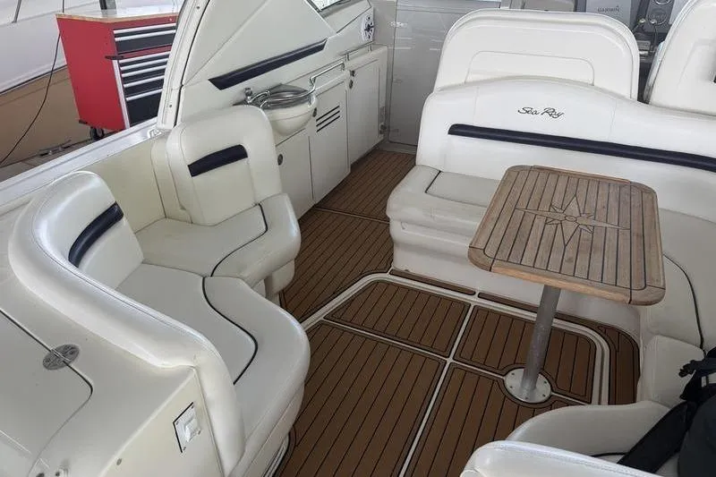 Slide: The Image of 2006 Sea Ray 38 Sundancer interior with white seating and wooden table. - 11