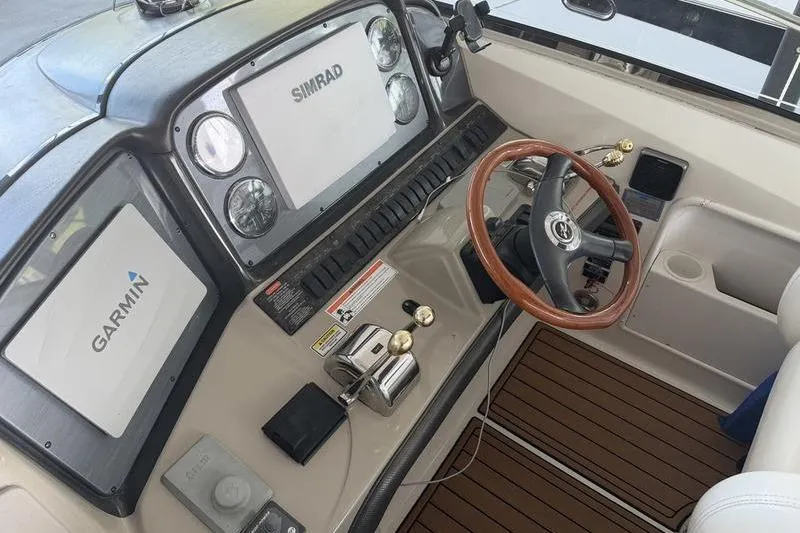 Slide: The Image of 2006 Sea Ray 38 Sundancer helm with Garmin and Simrad navigation systems. - 3
