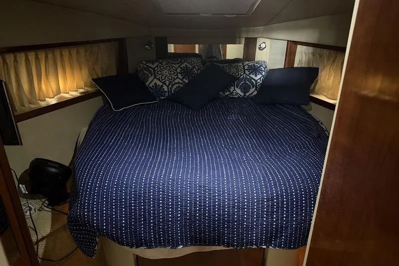 Slide: The Image of Interior cabin of 2006 Sea Ray 38 Sundancer with cozy bedding and decorative pillows. - 4