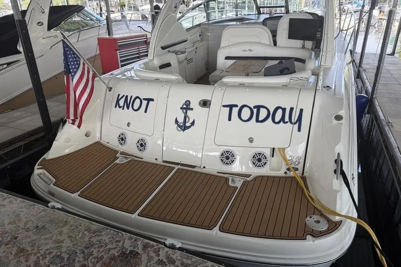 Slide: The Image of 2006 Sea Ray 38 Sundancer boat docked, featuring "Knot Today" name and American flag. - 5