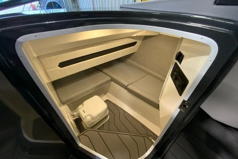 Slide: The Image of 2026 Cobalt A29 boat control panel with safety equipment and storage compartment. - 16