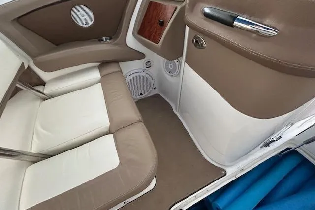 Slide: The Image of Interior of a 2011 Cobalt 302 boat with beige and white seating. - 10