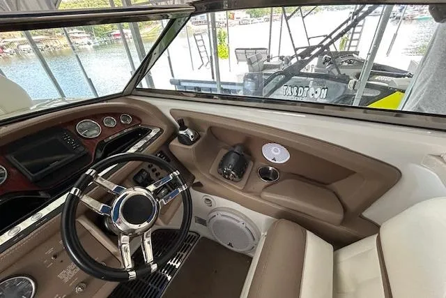 Slide: The Image of Interior view of 2011 Cobalt 302 boat cockpit with steering wheel and dashboard. - 12