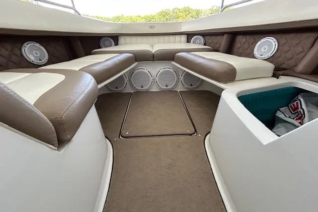 Slide: The Image of Interior of a 2011 Cobalt 302 boat with cushioned seating and speakers. - 13