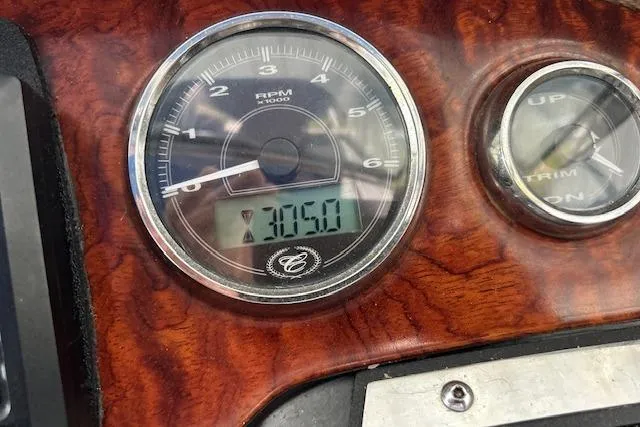 Slide: The Image of Close-up of 2011 Cobalt 302 RPM gauge displaying 3050 on wooden dashboard. - 19