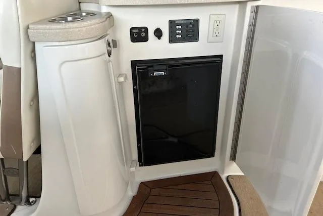 Slide: The Image of 2011 Cobalt 302 boat interior with mini fridge and control panel. - 20
