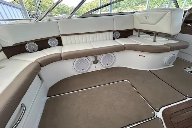 Slide: The Image of Luxurious interior of a 2011 Cobalt 302 boat with plush seating and built-in speakers. - 8