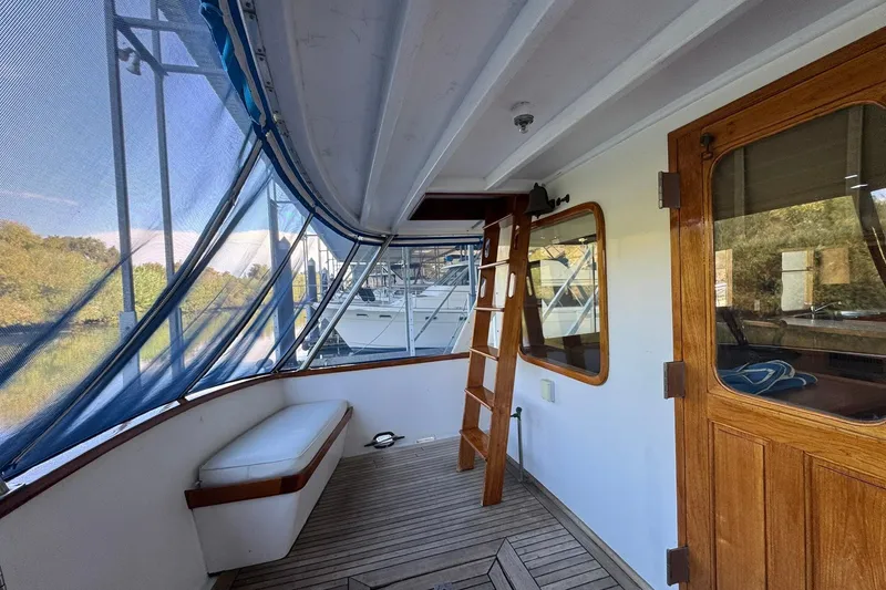 Slide: The Image of 1979 De Fever Pilot House boat interior with wooden accents and blue canopy. - 18