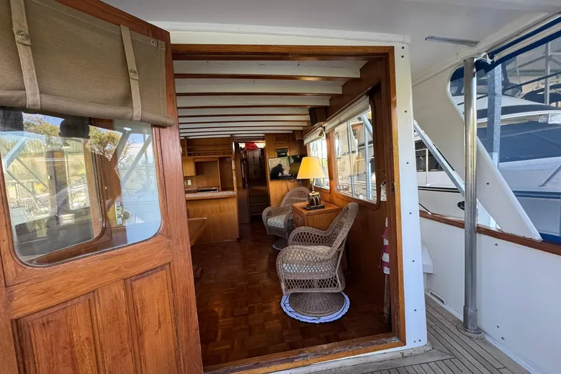 Slide: The Image of 1979 De Fever Pilot House interior with wicker chairs and wooden accents. - 22