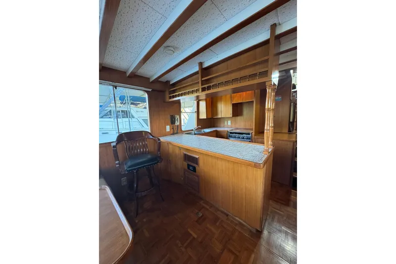 Slide: The Image of 1979 De Fever Pilot House interior with wooden cabinetry and seating. - 24