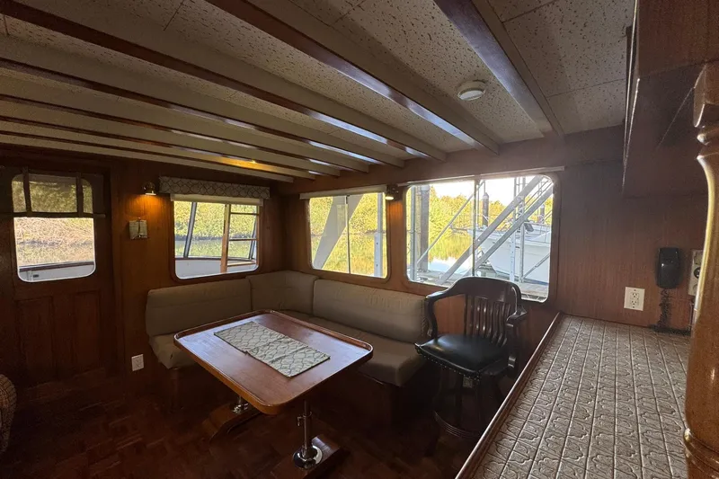 Slide: The Image of 1979 De Fever Pilot House interior with wooden decor and large windows. - 25