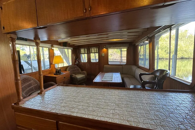 Slide: The Image of Interior of 1979 De Fever Pilot House with wood paneling and cozy seating area. - 26
