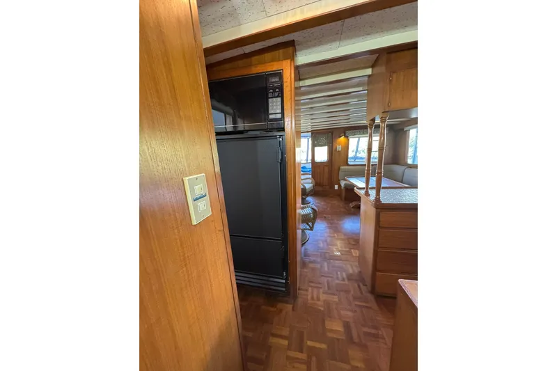 Slide: The Image of Interior of 1979 De Fever Pilot House with wood paneling and seating area. - 27