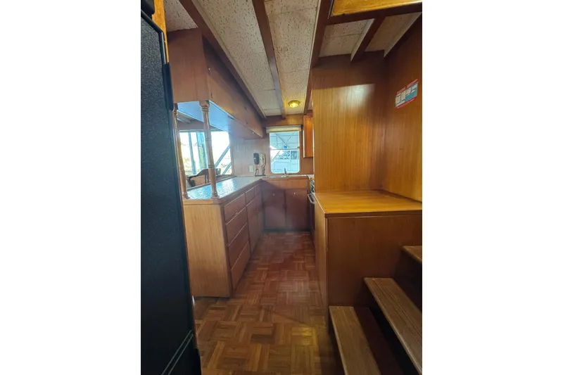 Slide: The Image of 1979 De Fever Pilot House interior with wooden cabinetry and parquet flooring. - 29
