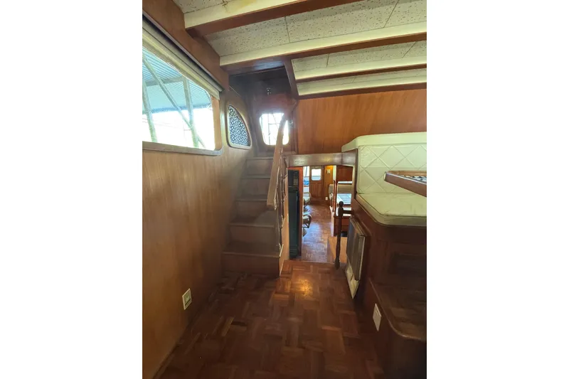 Slide: The Image of Interior of 1979 De Fever Pilot House with wooden stairs and cozy seating area. - 34