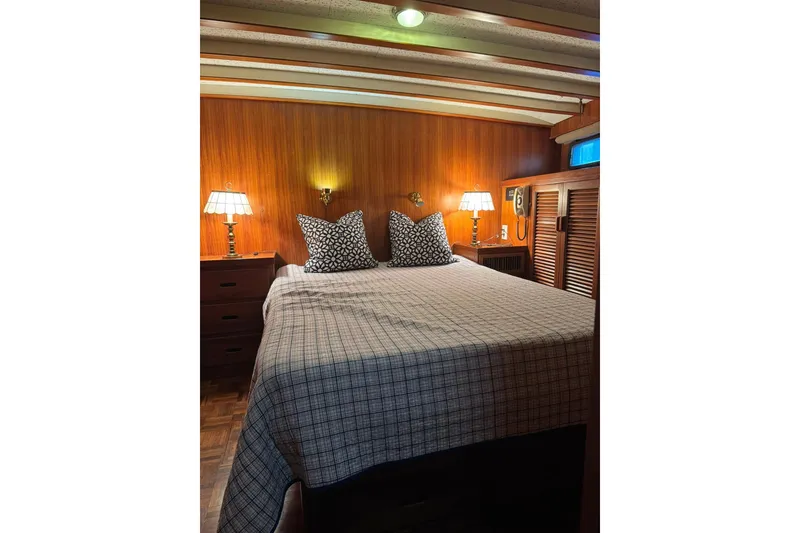 Slide: The Image of Cozy bedroom in 1979 De Fever Pilot House with wood paneling and soft lighting. - 40