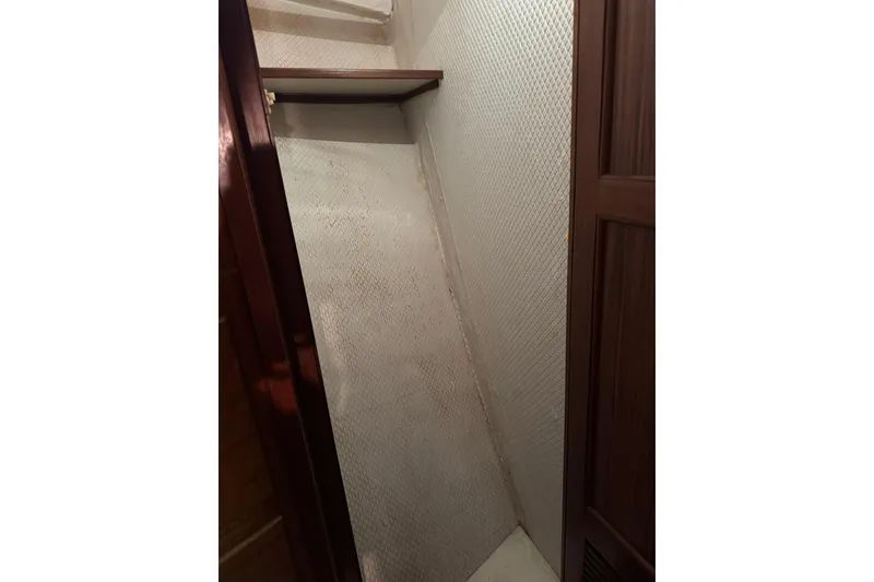 Slide: The Image of 1979 De Fever Pilot House interior with wooden shelves and textured walls. - 45