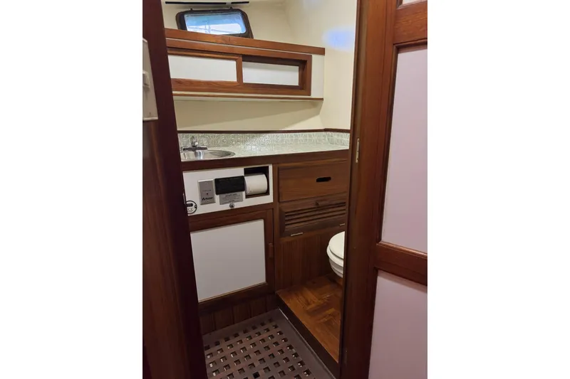 Slide: The Image of 1979 De Fever Pilot House bathroom with wood accents, sink, and toilet. - 47