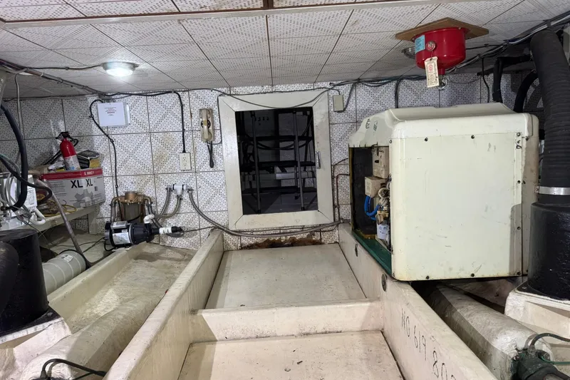 Slide: The Image of 1979 De Fever Pilot House engine room with equipment and wiring. - 54