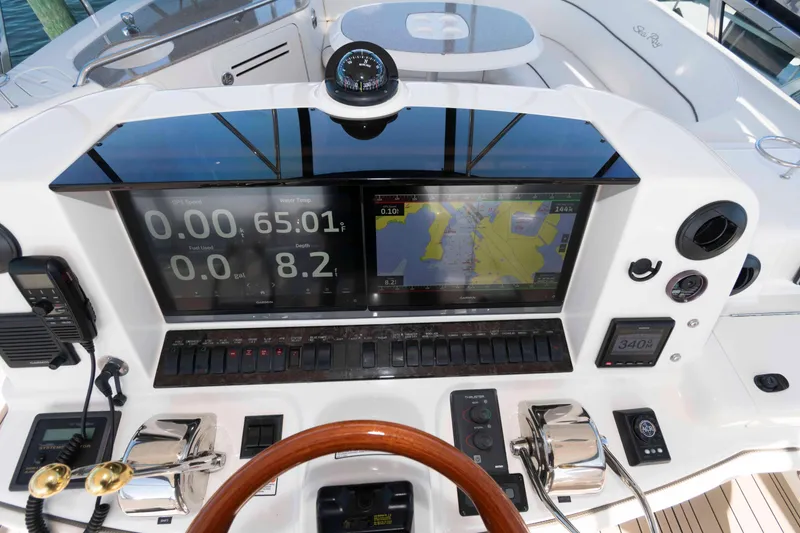 Slide: The Image of Control panel of a 2006 Sea Ray 52 Sedan Bridge yacht with navigation displays. - 10