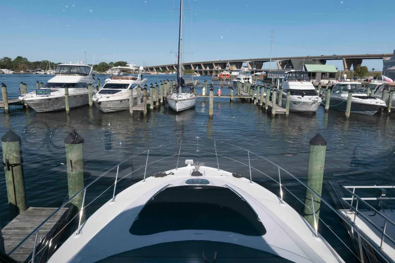Slide: The Image of 2006 Sea Ray 52 Sedan Bridge yacht docked at a marina with other boats. - 15
