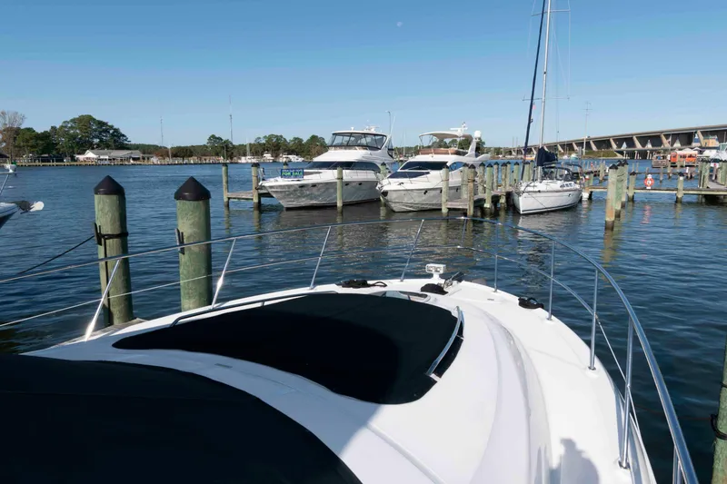 Slide: The Image of 2006 Sea Ray 52 Sedan Bridge yacht docked at marina with other boats. - 17