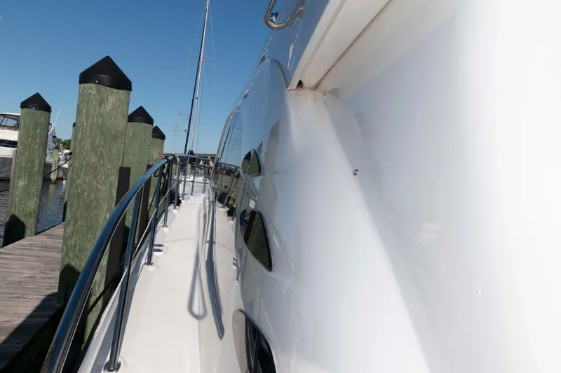 Slide: The Image of 2006 Sea Ray 52 Sedan Bridge yacht docked at marina, side view. - 18