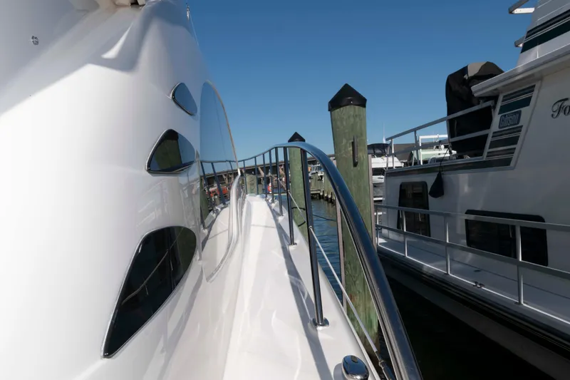 Slide: The Image of 2006 Sea Ray 52 Sedan Bridge yacht docked at marina, side view with railing. - 19