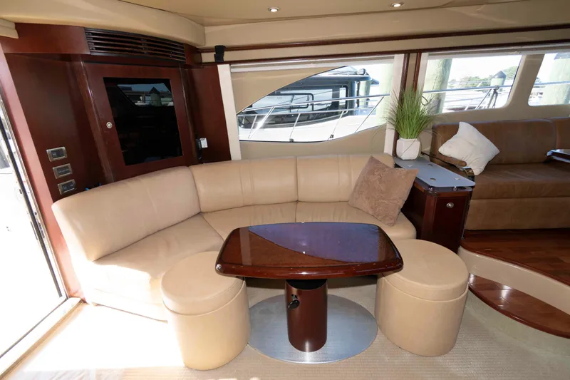 Slide: The Image of Luxurious interior of 2006 Sea Ray 52 Sedan Bridge yacht with beige seating and wooden accents. - 22