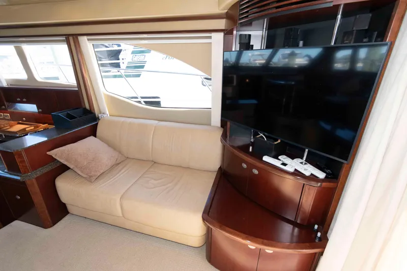 Slide: The Image of Luxurious interior of 2006 Sea Ray 52 Sedan Bridge with sofa and entertainment center. - 23