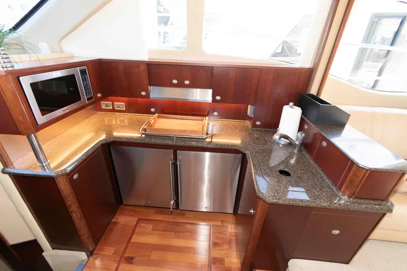 Slide: The Image of Luxurious kitchen area in a 2006 Sea Ray 52 Sedan Bridge yacht. - 26
