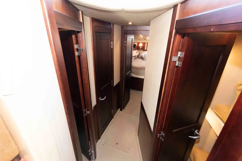 Slide: The Image of Interior hallway of 2006 Sea Ray 52 Sedan Bridge with wooden doors and cozy lighting. - 27