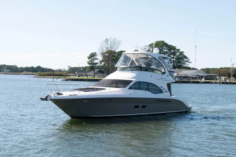 Slide: The Image of 2006 Sea Ray 52 Sedan Bridge yacht cruising on a calm waterway. - 3