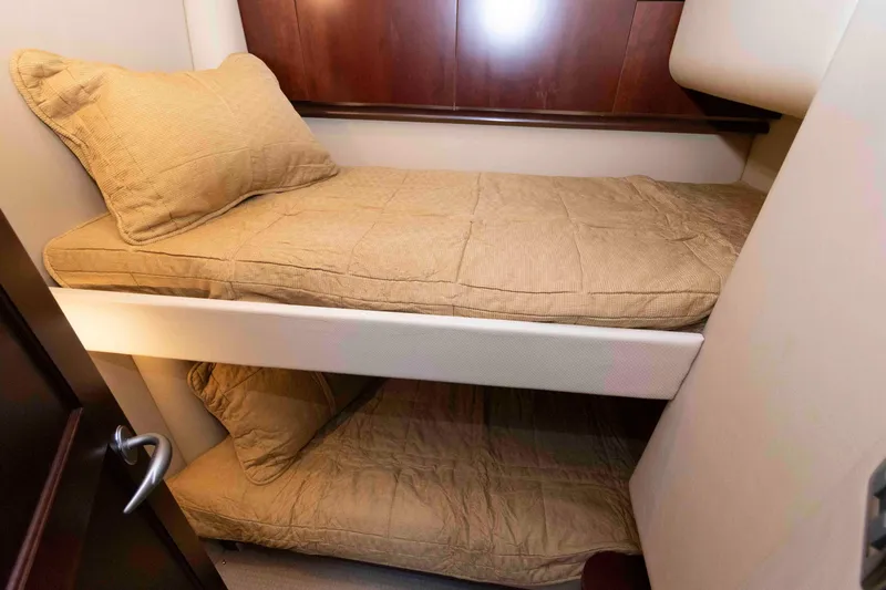 Slide: The Image of Bunk beds in 2006 Sea Ray 52 Sedan Bridge yacht cabin with beige bedding. - 31
