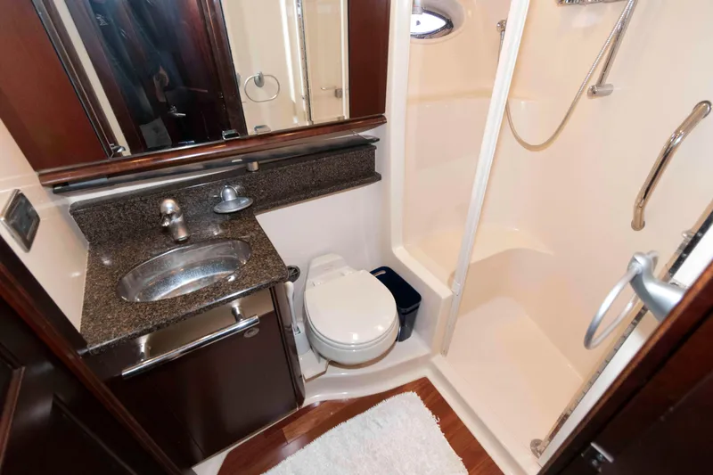 Slide: The Image of Luxurious bathroom in 2006 Sea Ray 52 Sedan Bridge yacht with shower and granite countertop. - 32
