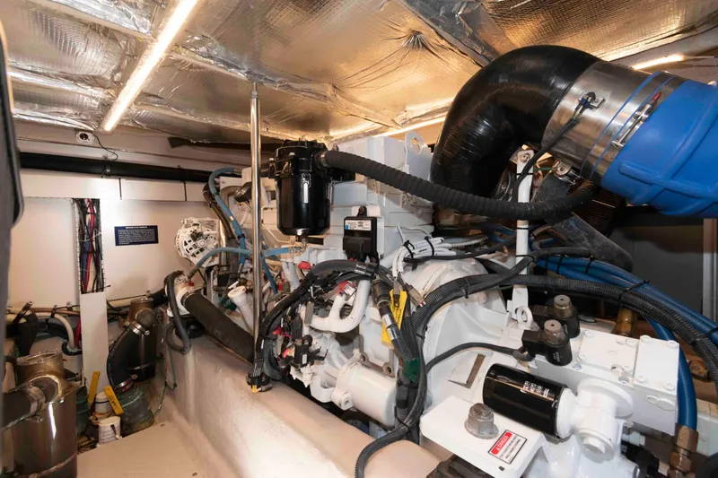 Slide: The Image of Engine room of 2006 Sea Ray 52 Sedan Bridge yacht, showcasing mechanical components and wiring. - 35
