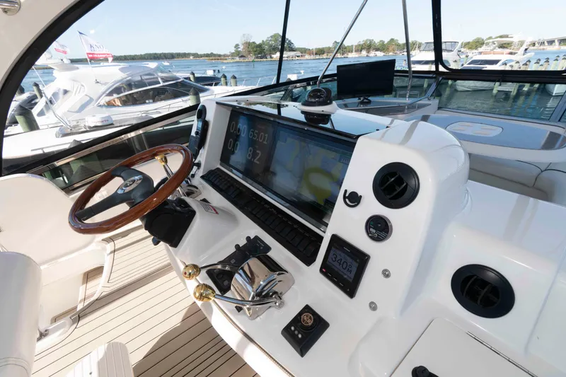 Slide: The Image of Helm of 2006 Sea Ray 52 Sedan Bridge with modern navigation equipment and wooden steering wheel. - 9
