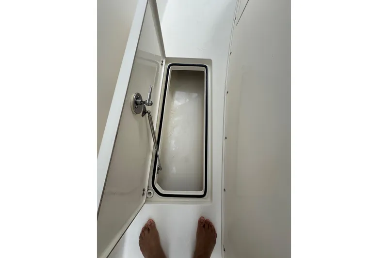 Slide: The Image of 2014 Cobia 296 Center Console storage compartment with open hatch, viewed from above. - 10