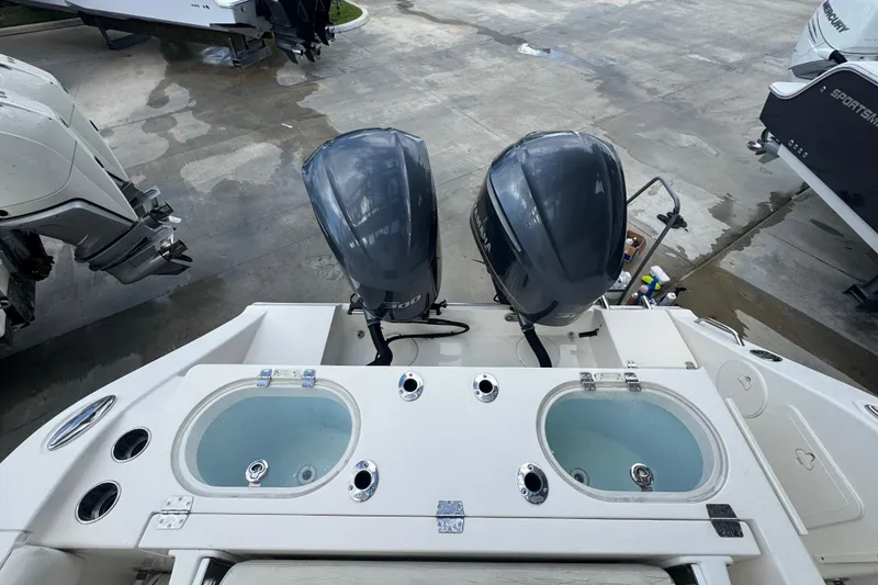 Slide: The Image of 2014 Cobia 296 Center Console with dual outboard engines and live wells. - 12
