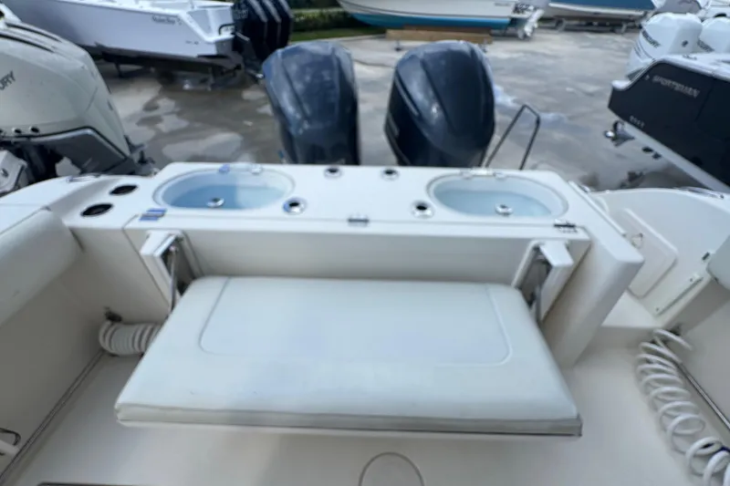 Slide: The Image of 2014 Cobia 296 Center Console boat with dual engines and seating area. - 13