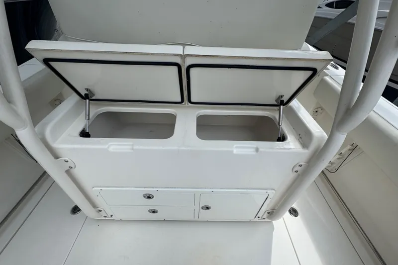 Slide: The Image of 2014 Cobia 296 Center Console boat storage compartments with open lids. - 15