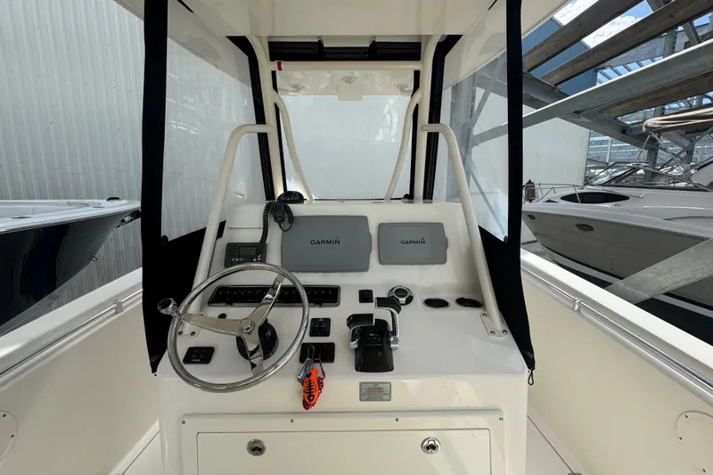 Slide: The Image of 2014 Cobia 296 Center Console boat helm with Garmin navigation system. - 18