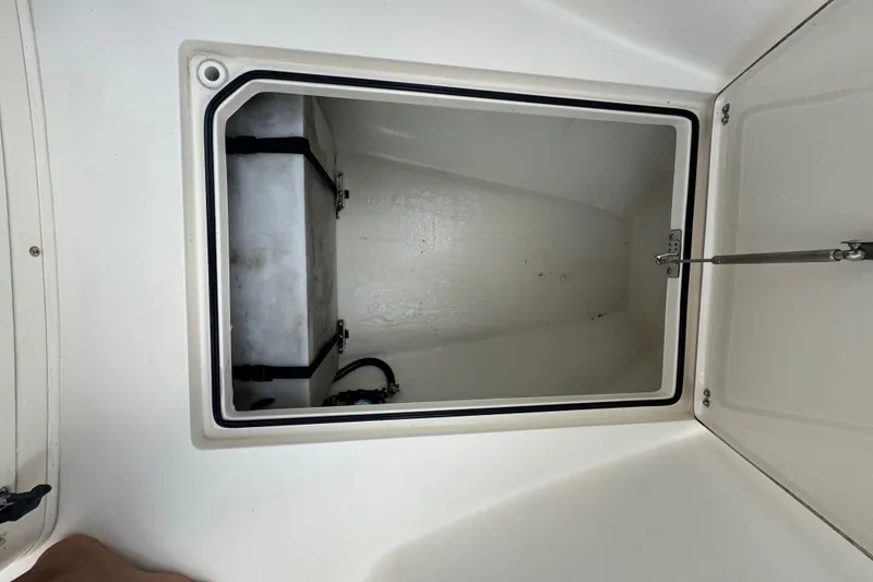 Slide: The Image of Open storage compartment on 2014 Cobia 296 Center Console boat. - 21